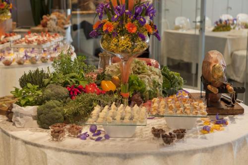 a table with many different types of food on it at Hotel Ristorante Ala d'Oro in Lugo