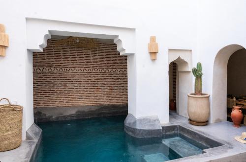 a swimming pool in the middle of a house at RIAD MAJWRIL in Marrakesh