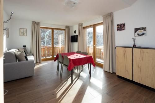 a living room with a table with a red towel on it at BAITA NOEMI in Livigno