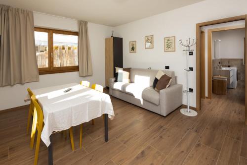 a living room with a white table and a couch at BAITA NOEMI in Livigno