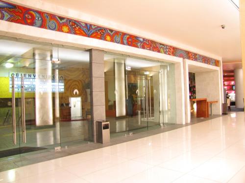 an empty lobby with glass doors in a building at Aranzazu Centro Historico in Guadalajara