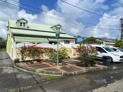 um carro branco estacionado em frente a uma casa em Maison d'une chambre avec wifi a Pointe a Pitre em Pointe-à-Pitre