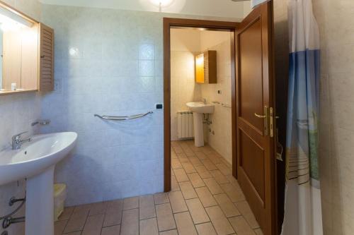 a bathroom with a sink and a toilet and a shower at Agriturismo Casella Del Piano in Gubbio