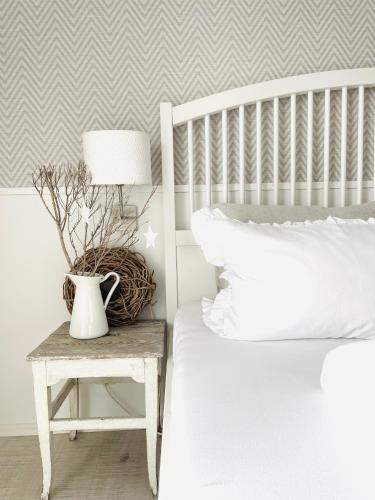 a bedroom with a bed and a table with a lamp at Das Ruebezahl in Reit im Winkl