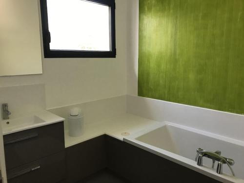 a bathroom with a tub and a sink and a window at Villa Alberes Sorede 7 km of beaches in Sorède
