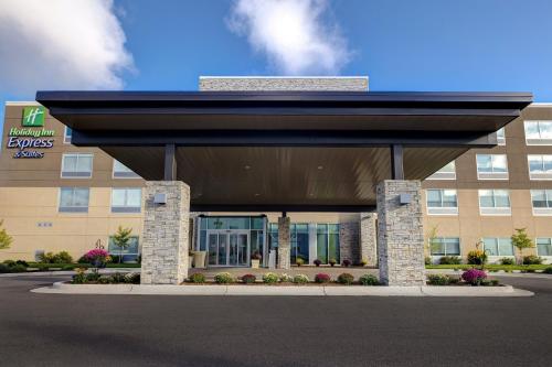 a large building with a black awning in front of it at Holiday Inn Express & Suites - Grand Rapids South - Wyoming by IHG in Wyoming