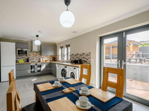 a kitchen and dining room with a table and chairs at Westertonhill Lodges in Balloch