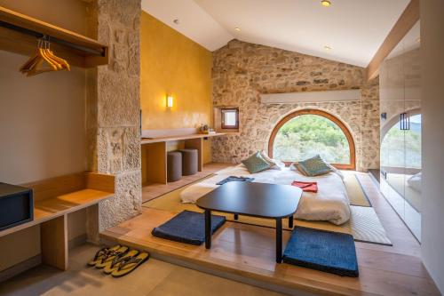 een slaapkamer met een bed en een tafel in een kamer bij Hotel japonès Puigpinós in Lladurs