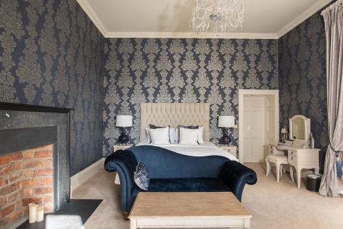 a bedroom with a large bed and a fireplace at Boyne House Slane in Slane