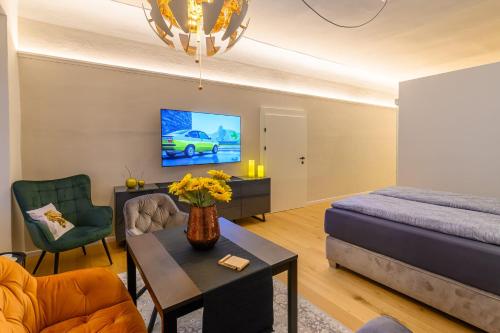 a living room with a couch and a bed and a table at Gh Alte Post Kombi 2 - 6 Gäste in Gmünd in Kärnten