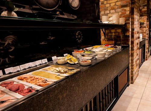 a buffet line with many different types of food at Dorint Hotel Düren in Düren - Eifel