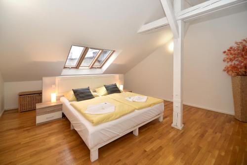 a bedroom with a large bed in a attic at Historic Centre Apartments I in Prague