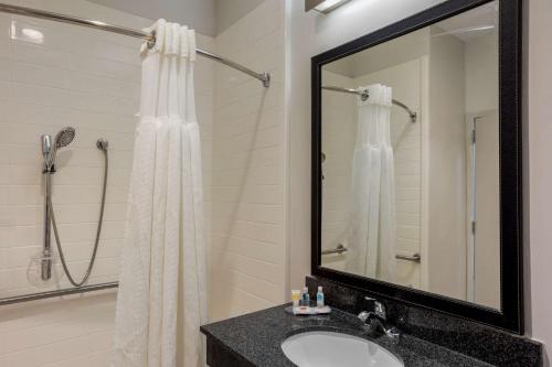 a bathroom with a sink and a shower with a mirror at Comfort Inn & Suites Mt Laurel-Philadelphia in Mount Laurel