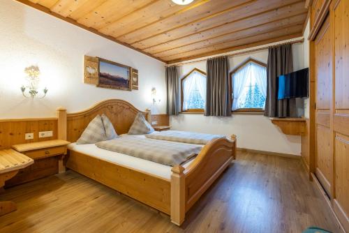 a bedroom with a bed in a room with wooden ceilings at Das Geierberg in Filzmoos