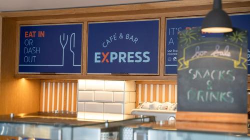 a fast food restaurant with signs on the wall at Holiday Inn Express Aberdeen City Centre by IHG in Aberdeen