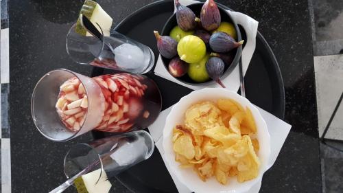 a table topped with plates of fruit and a bowl of nuts at Casa Olivar B&B in Tocon