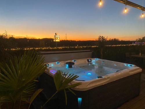 a jacuzzi tub with lights in a backyard at Wellness Dome Penthouse in Kerkrade
