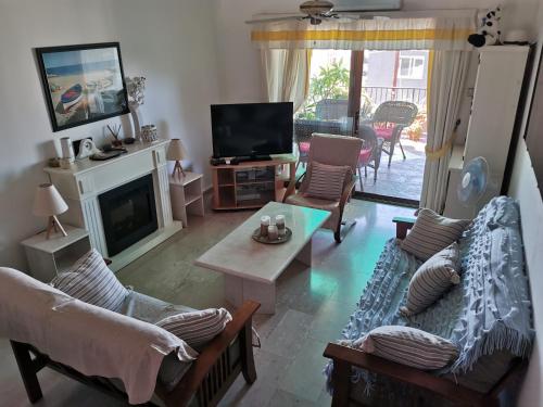 a living room with couches and a tv and a fireplace at MEDITERRANEAN VALLEY in Paphos City