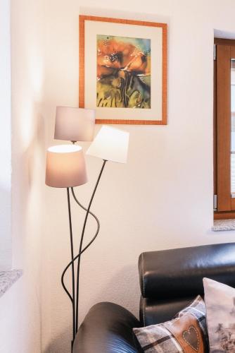 a living room with two lamps and a couch at Landhaus Aggenstein in Haldensee