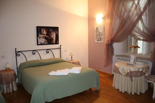 a bedroom with a green bed and a window at City's House Guest House in Bergamo