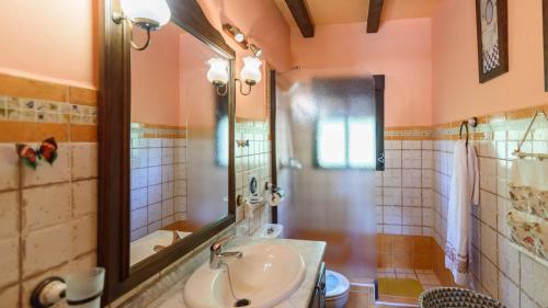 a bathroom with a sink and a mirror at Casa Rural La Higuera El Gastor by Ruralidays in El Gastor