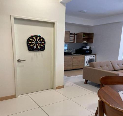 a living room with a door with a clock on it at DS Timurbay Residence in Kuantan