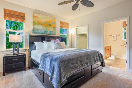 a bedroom with a large bed and a bathroom at Pili Mai 1L in Koloa