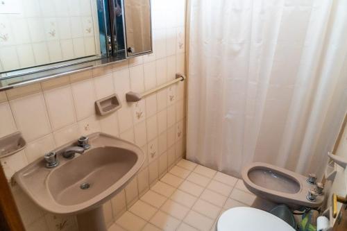 a bathroom with a sink and a toilet at Departamento Serena in San Juan