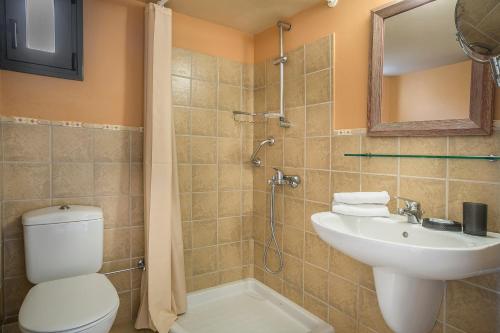 a bathroom with a toilet and a sink and a shower at Crystal Palace - Luce in Skala Kefalonias
