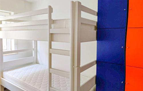 a white bunk bed with a ladder in a room at Goudstrand in Oostduinkerke