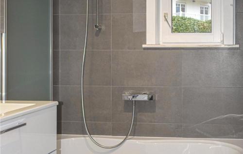 a shower in a bathroom with a bath tub at Goudstrand in Oostduinkerke