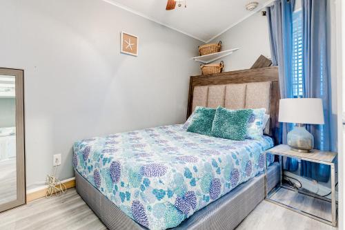 a bedroom with a bed with a blue comforter at Casa Del Mar Skip to the Beach 294 in Galveston