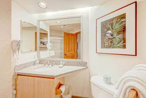 a bathroom with a sink and a mirror at Ski-In Ski-Out Squaw Valley Lodge Slopeside Townhome in Olympic Valley