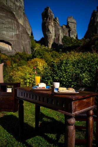 a table with food on it with rocks in the background at Pyrgos Adrachti in Kalabaka