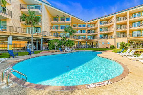 a large swimming pool in front of a building at Marvilla Condo My Happy Place in Galveston