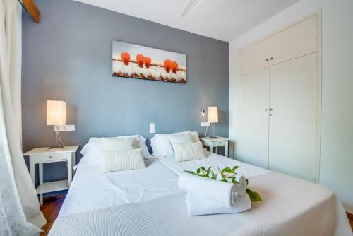 a bedroom with a large white bed with two tables at Ideal Property Mallorca - Es Claperas in Inca