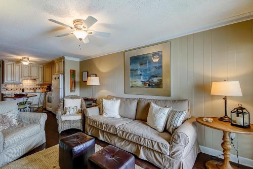 a living room with a couch and a table at Beach Cottage at OD in Myrtle Beach