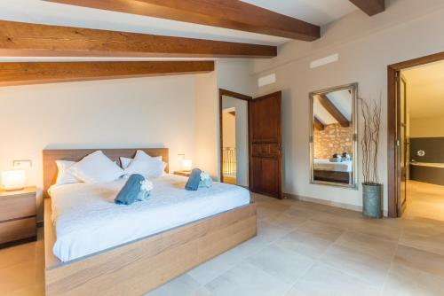a bedroom with a large white bed with blue pillows at Ideal Property Mallorca - Pleta 8 PAX in Manacor