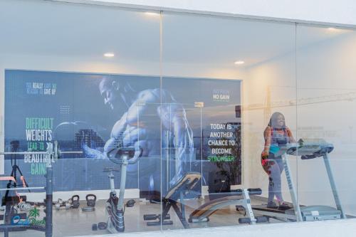 a woman standing in front of a store window at OASIS PARK RESIDENCE in East Legon