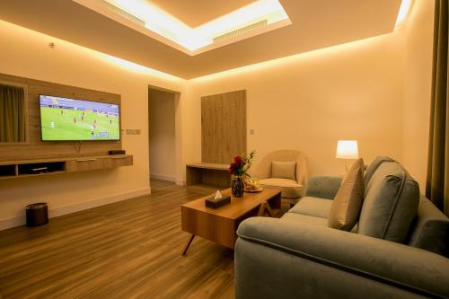 a living room with a couch and a tv at Luxury Night Al Mounisea in Riyadh