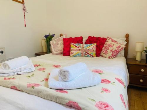 a bed with towels and pillows on it at The Corner Lodge in Portland