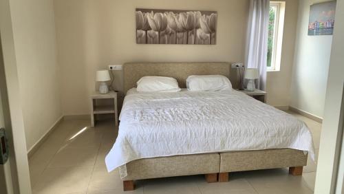 a bedroom with a large bed with white sheets and pillows at Seaview 2 Bedroom - apt40 - Blue Bay Curacao in Willemstad