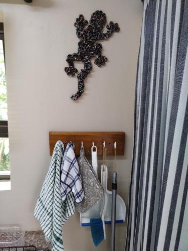 a room with a rack of towels on a wall at Dollies place in Bazley Beach