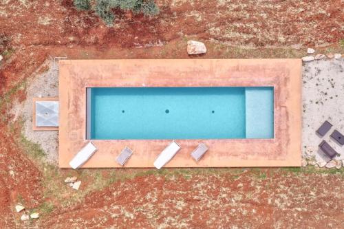 an overhead view of a swimming pool in a yard at Bianco Trullo by Raro Villas in Latiano
