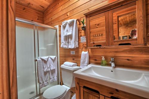 a bathroom with a toilet and a shower and a sink at Motel Long Lake and Cottages in Long Lake