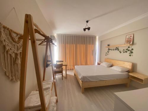 a bedroom with a bed and a desk and a chair at Santa Suites- Near Saint Nicholas Church in Demre