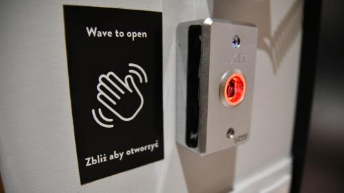a sign on a refrigerator with a hand on it at Wine Apartments in Kraków