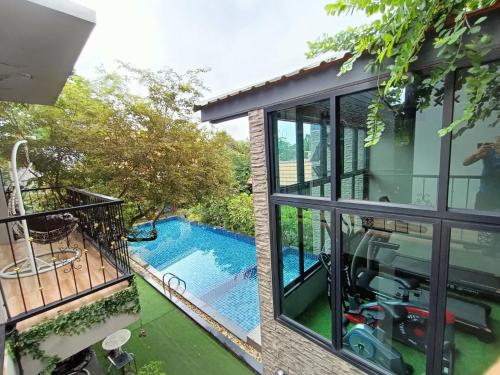 an external view of a house with a swimming pool at Aen Guy Boutique Hotel in Sukhothai