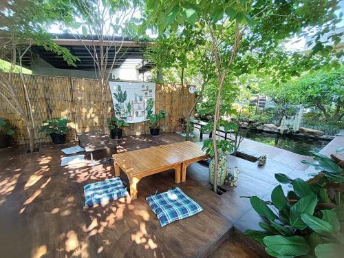 a patio with a wooden table and chairs at Aen Guy Boutique Hotel in Sukhothai