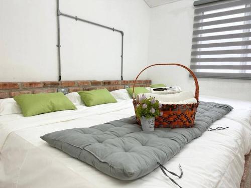 a bed with a basket on top of it at Ipoh Family Homestay Perak Cave Temple 8pax SY16 in Ipoh